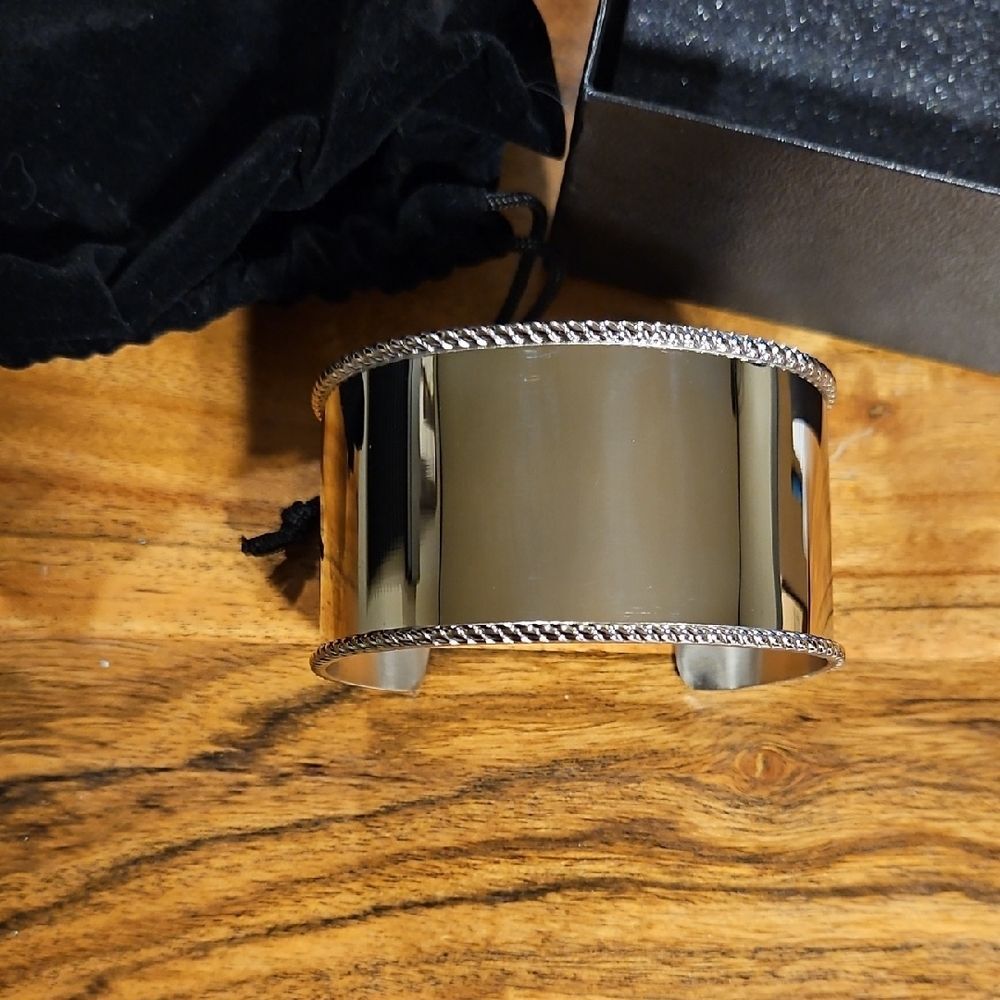 Wide stainless steel cuff bracelet with a rope-detailed edge.